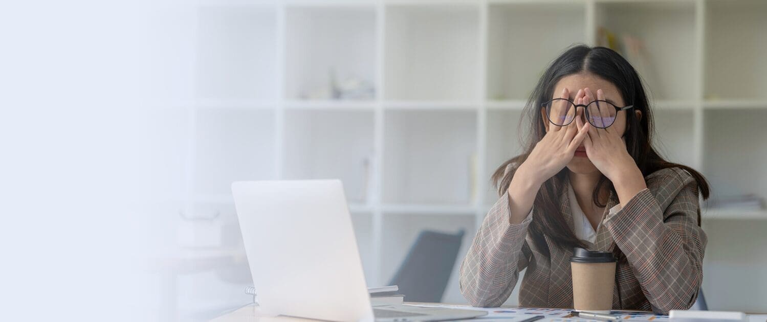 tired business woman sitting at desk